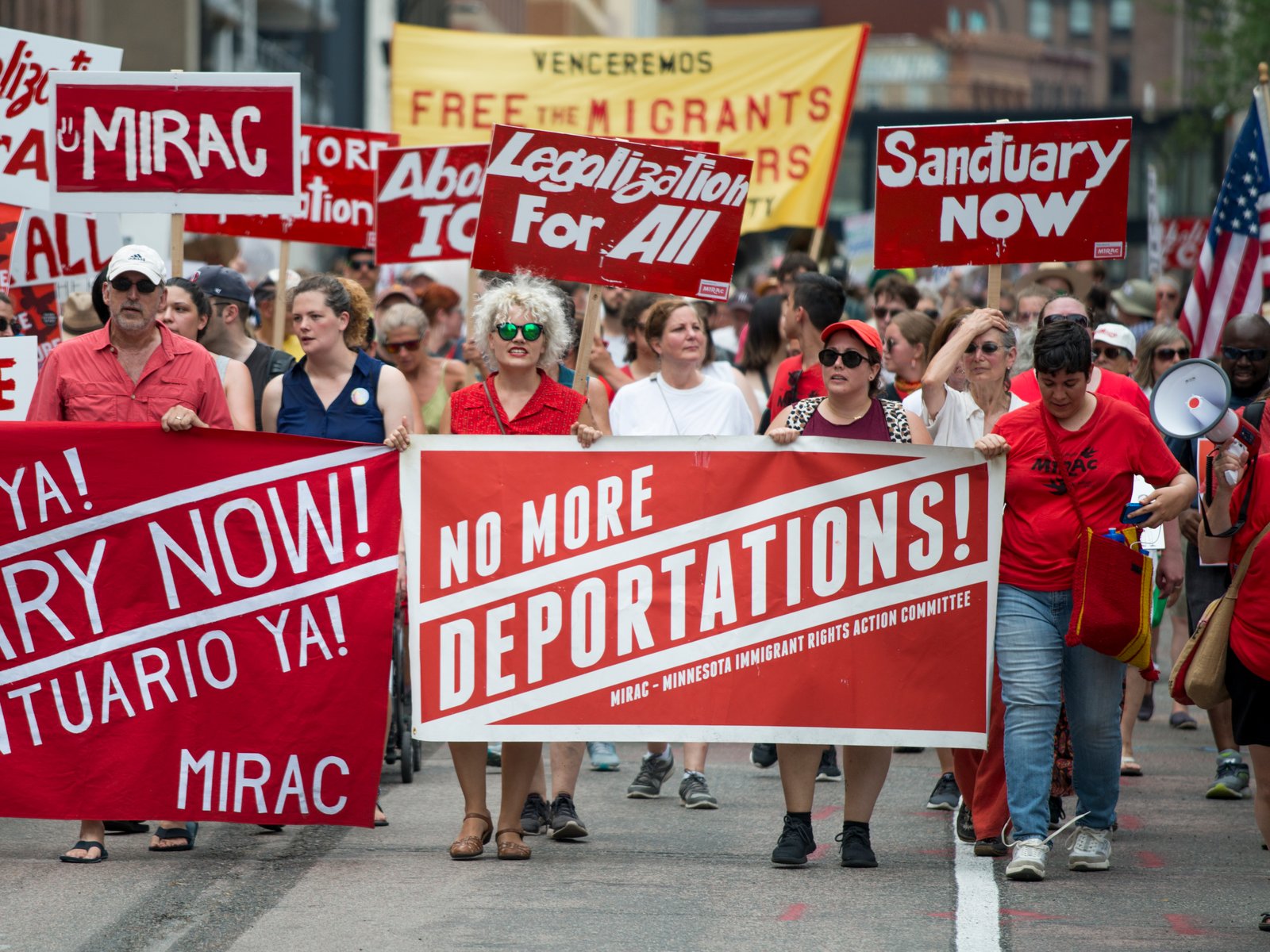 Families holding signs at a Families Belong Together march and day of action